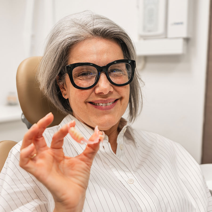 Comparison of a dental implant, a bridge and a partial denture